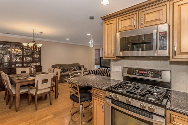 Chandelier, Dining room, Interior, Kitchen, Living room, Pendant Lights, Recessed Lighting, Stainless Steel Appliances, Wood Texture Flooring