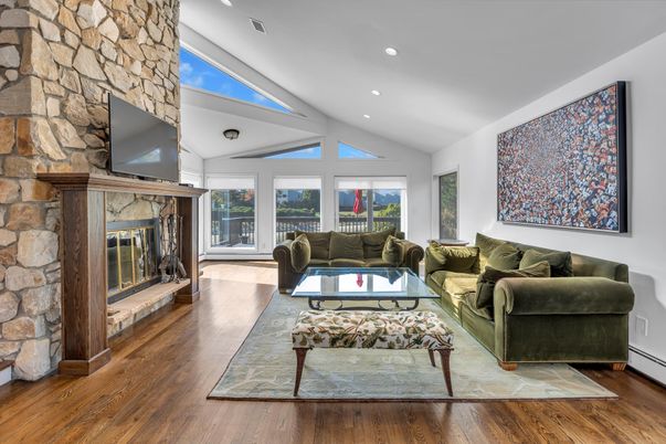 Fireplace, Interior, Living room, Recessed Lighting, Stone Walls, Wood Texture Flooring