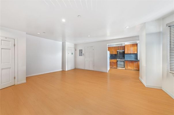 Empty room, Interior, Kitchen, Recessed Lighting, Stainless Steel Appliances, Wood Texture Flooring