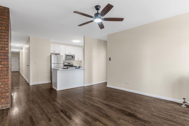 Empty room, Interior, Kitchen, Recessed Lighting, Stainless Steel Appliances, Stone Walls, Wood Texture Flooring