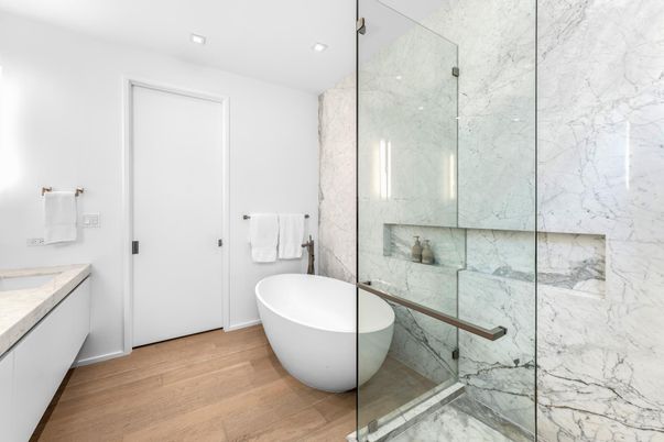 Bathroom, Free Standing Baths, Glass Shower, Interior, Marble Walls, Recessed Lighting, Wood Texture Flooring