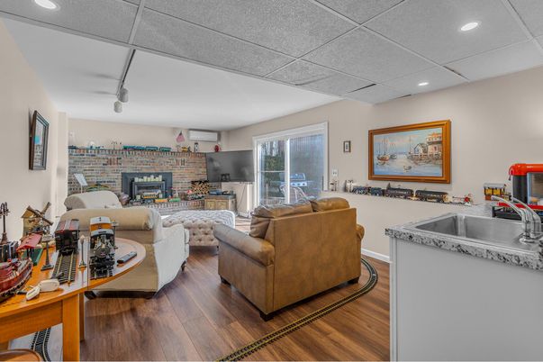 Fireplace, Interior, Living room, Recessed Lighting, Stone Walls, Wood Texture Flooring
