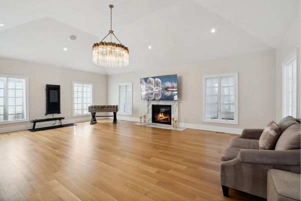 Billiard Table, Chandelier, Fireplace, Game Room, Interior, Living room, Pendant Lights, Recessed Lighting, Wood Texture Flooring