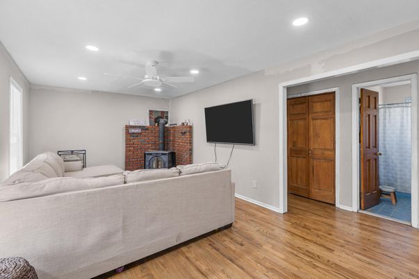 Fireplace, Interior, Living room, Recessed Lighting, Stone Walls, Wood Texture Flooring
