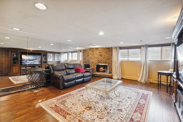 Fireplace, Interior, Living room, Recessed Lighting, Stone Walls, Wood Texture Flooring