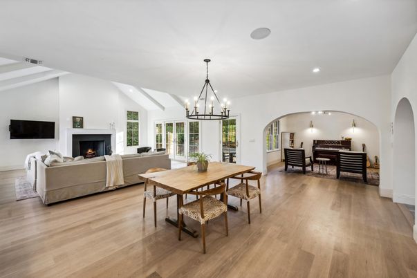 Chandelier, Dining room, Fireplace, Interior, Living room, Pendant Lights, Recessed Lighting, Wood Texture Flooring