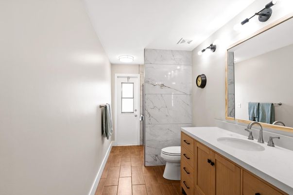 Bathroom, Glass Shower, Interior, Marble Walls, Wood Texture Flooring
