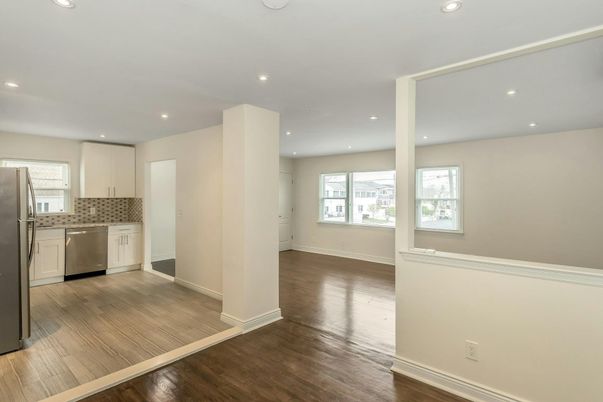 Empty room, Interior, Kitchen, Recessed Lighting, Stainless Steel Appliances, Wood Texture Flooring