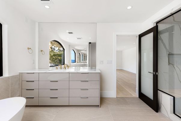 Bathroom, Dual Sink Vanities, Free Standing Baths, Glass Shower, Interior, Marble Walls, Recessed Lighting, Wood Texture Flooring