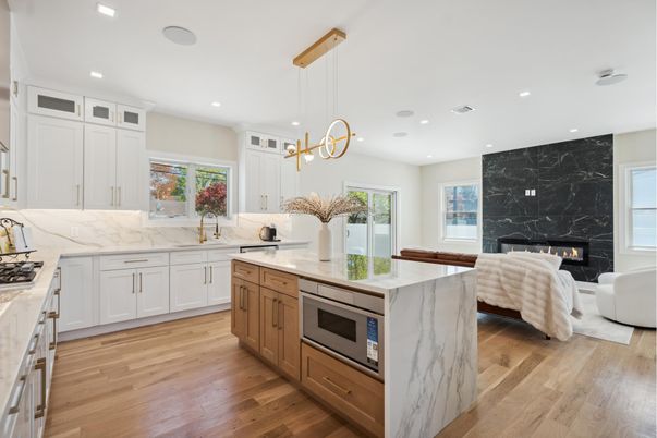 Fireplace, Interior, Kitchen, Living room, Marble Walls, Pendant Lights, Recessed Lighting, Stainless Steel Appliances, Wood Texture Flooring