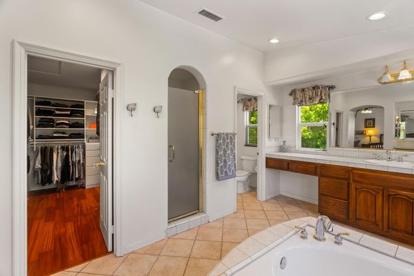 Bathroom, Dual Sink Vanities, Interior, Recessed Lighting, Tile Countertops, Walk-in Closets, Wood Texture Flooring