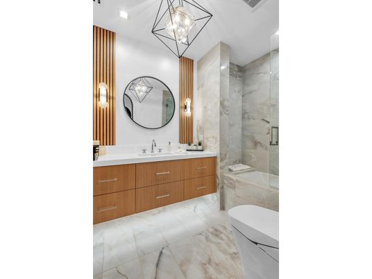 Bathroom, Dual Sink Vanities, Glass Shower, Interior, Marble, Marble Walls, Pendant Lights, Recessed Lighting