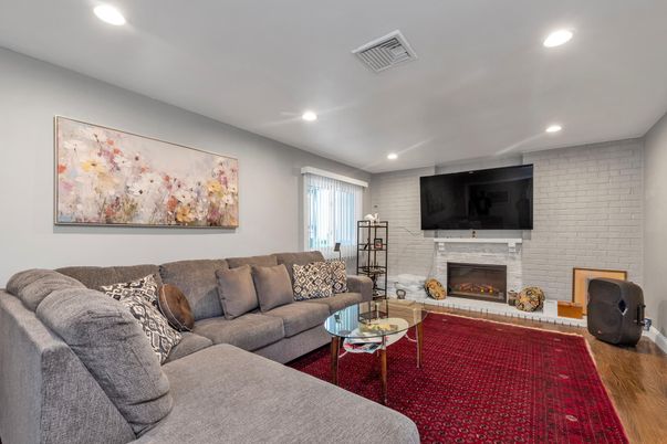 Fireplace, Interior, Living room, Recessed Lighting, Stone Walls, Wood Texture Flooring