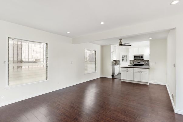 Empty room, Interior, Kitchen, Recessed Lighting, Stainless Steel Appliances, Wood Texture Flooring