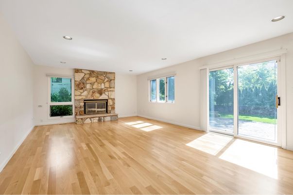 Empty room, Fireplace, Interior, Recessed Lighting, Stone Walls, Wood Texture Flooring