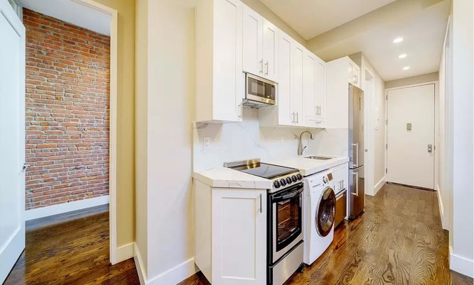Interior, Kitchen, Recessed Lighting, Stone Walls, Washer, Wood Texture Flooring