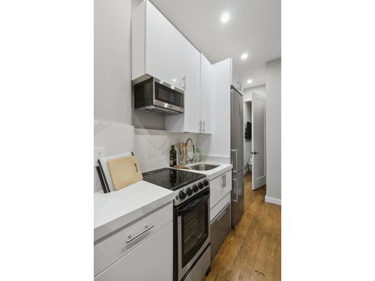 Interior, Kitchen, Recessed Lighting, Tile Countertops, Wood Texture Flooring
