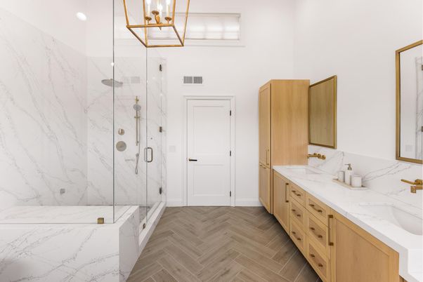 Bathroom, Dual Sink Vanities, Glass Shower, Interior, Marble Walls, Pendant Lights, Recessed Lighting, Wood Texture Flooring