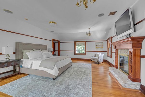 Bedroom, Chandelier, Fireplace, Interior, Recessed Lighting, Wood Texture Flooring