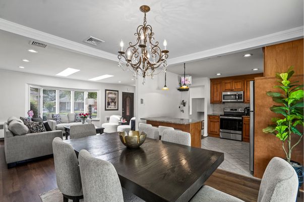 Chandelier, Dining room, Interior, Kitchen, Living room, Pendant Lights, Recessed Lighting, Stainless Steel Appliances, Wood Texture Flooring