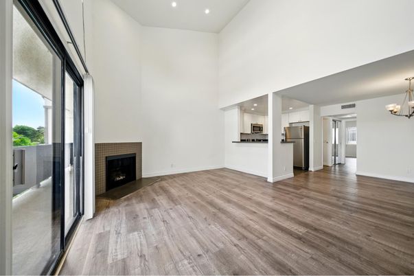Chandelier, Empty room, Fireplace, Interior, Kitchen, Recessed Lighting, Stainless Steel Appliances, Wood Texture Flooring