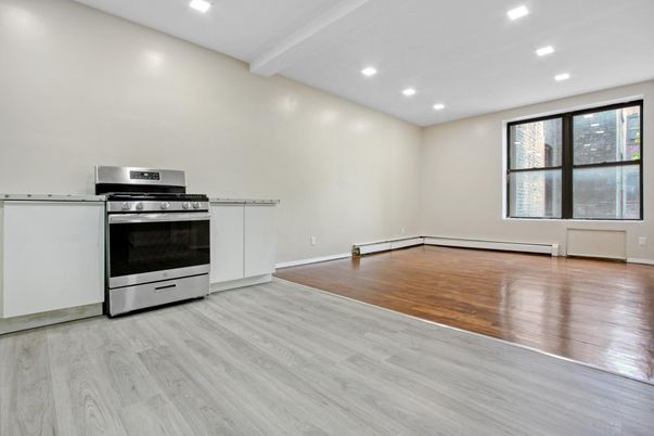 Empty room, Interior, Kitchen, Recessed Lighting, Stainless Steel Appliances, Wood Texture Flooring