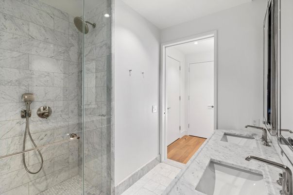 Bathroom, Dual Sink Vanities, Glass Shower, Interior, Marble, Marble Walls, Recessed Lighting, Wood Texture Flooring