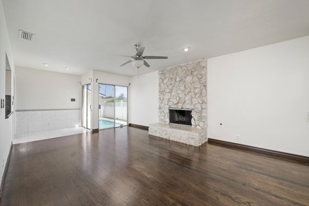 Empty room, Fireplace, Interior, Recessed Lighting, Stone Walls, Wood Texture Flooring