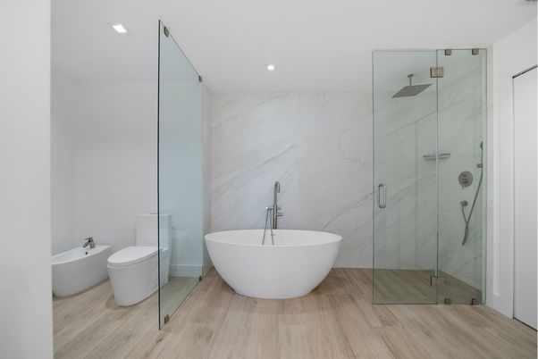 Bathroom, Free Standing Baths, Glass Shower, Interior, Marble Walls, Recessed Lighting, Wood Texture Flooring