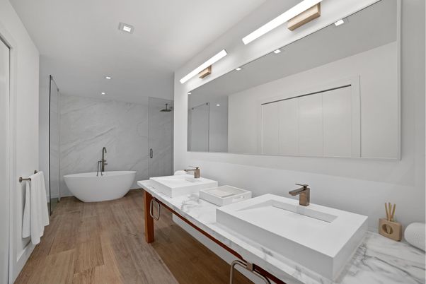 Bathroom, Dual Sink Vanities, Free Standing Baths, Interior, Marble Walls, Recessed Lighting, Wood Texture Flooring