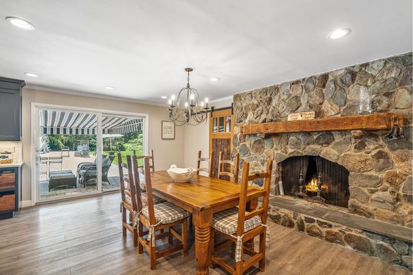 Chandelier, Dining room, Fireplace, Interior, Recessed Lighting, Stone Walls, Wood Texture Flooring