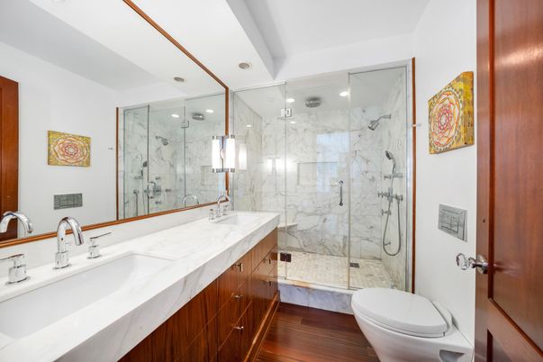 Bathroom, Dual Sink Vanities, Glass Shower, Interior, Marble Walls, Recessed Lighting, Wood Texture Flooring
