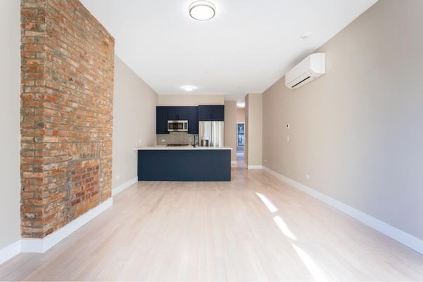 Empty room, Interior, Kitchen, Recessed Lighting, Stainless Steel Appliances, Stone Walls, Wood Texture Flooring