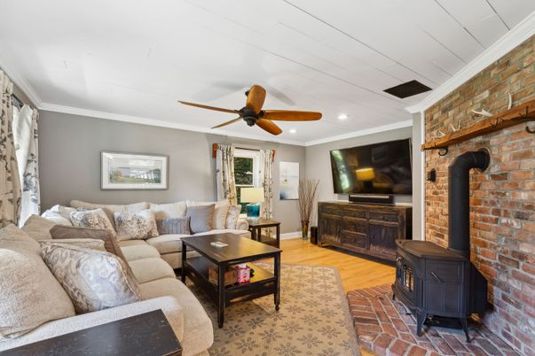 Fireplace, Interior, Living room, Recessed Lighting, Stone Walls, Wood Texture Flooring