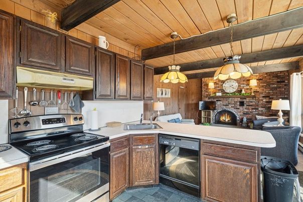 Fireplace, Interior, Kitchen, Pendant Lights, Stainless Steel Appliances, Stone Walls, Wooden Beams, Wooden Ceilings
