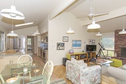 Dining room, Fireplace, Interior, Kitchen, Living room, Pendant Lights, Stainless Steel Appliances, Stone Walls, Wood Texture Flooring