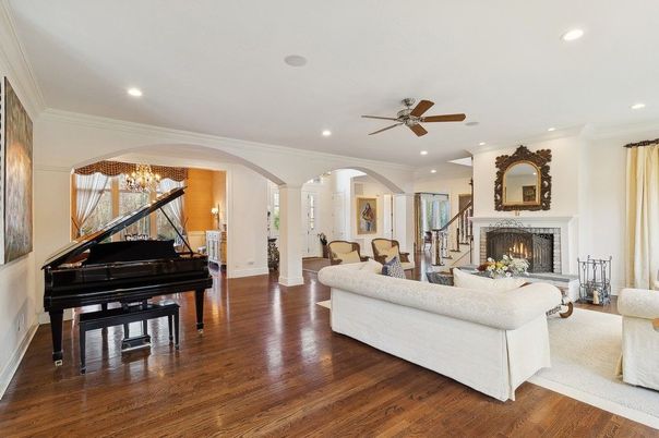 Chandelier, Fireplace, Interior, Living room, Piano, Recessed Lighting, Wood Texture Flooring