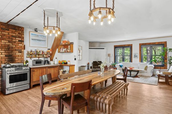 Dining room, Fireplace, Interior, Kitchen, Living room, Pendant Lights, Stainless Steel Appliances, Stone Walls, Wood Texture Flooring
