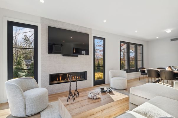 Dining room, Fireplace, Interior, Living room, Recessed Lighting, Stone Walls, Wood Texture Flooring