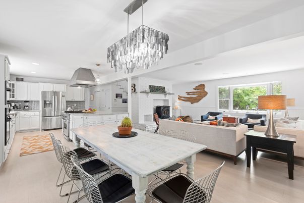 Chandelier, Dining room, Fireplace, Interior, Kitchen, Living room, Pendant Lights, Recessed Lighting, Stainless Steel Appliances, Stone Walls, Wood Texture Flooring
