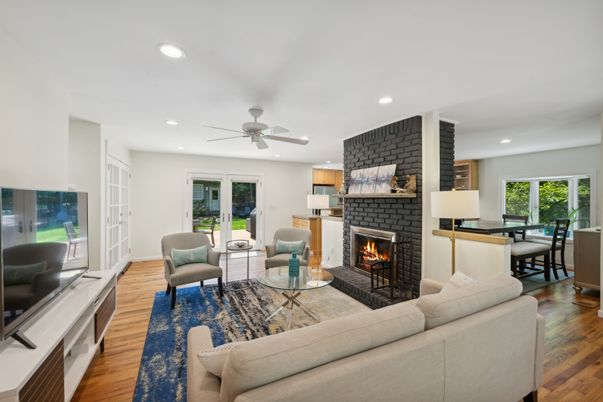 Dining room, Fireplace, Interior, Living room, Recessed Lighting, Stone Walls, Wood Texture Flooring