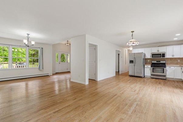 Chandelier, Empty room, Interior, Kitchen, Pendant Lights, Recessed Lighting, Stainless Steel Appliances, Wood Texture Flooring