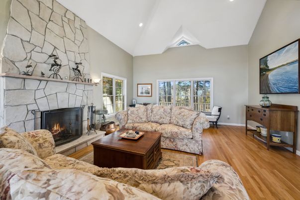 Fireplace, Interior, Living room, Recessed Lighting, Stone Walls, Wood Texture Flooring