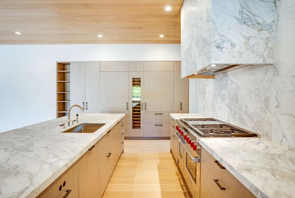 Interior, Kitchen, Marble Walls, Recessed Lighting, Stainless Steel Appliances, Wood Texture Flooring