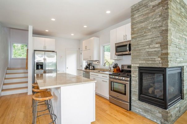 Fireplace, Interior, Kitchen, Recessed Lighting, Stainless Steel Appliances, Stone Walls, Wood Texture Flooring