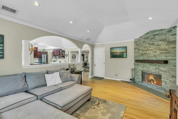 Fireplace, Interior, Living room, Recessed Lighting, Stone Walls, Wood Texture Flooring