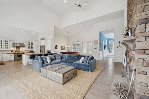 Fireplace, Interior, Kitchen, Living room, Pendant Lights, Recessed Lighting, Stainless Steel Appliances, Stone Walls, Wood Texture Flooring