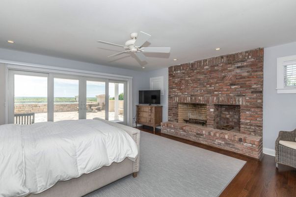 Bedroom, Fireplace, Interior, Recessed Lighting, Stone Walls, Wood Texture Flooring