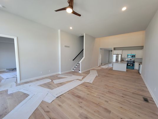 Empty room, Interior, Kitchen, Recessed Lighting, Stainless Steel Appliances, Wood Texture Flooring