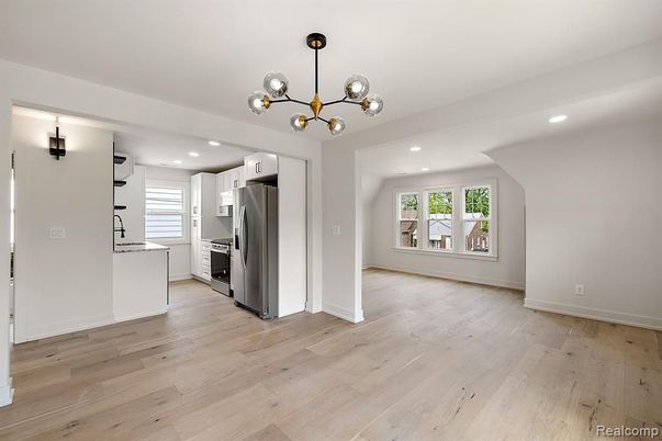Empty room, Interior, Kitchen, Pendant Lights, Recessed Lighting, Stainless Steel Appliances, Wood Texture Flooring